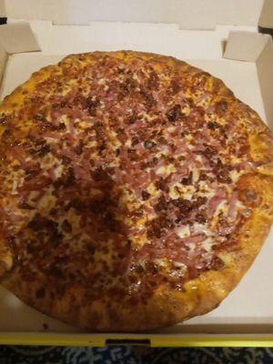 Bacon and ham pizza, it wasn't cut.