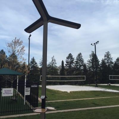 A charging cell station next to volley ball courts.