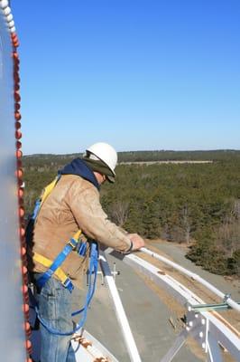 Removing and relocating navigation lights on the Joint Base Cape Cod water tower.