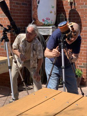 Celestron telescope and camera capturing the eclipse.