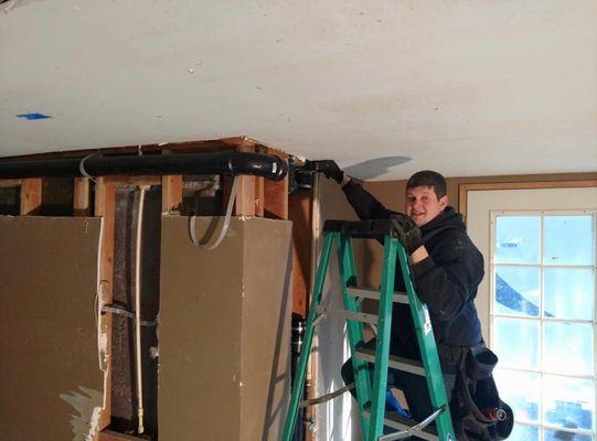 Nick plumbing the drain from attic to basement.