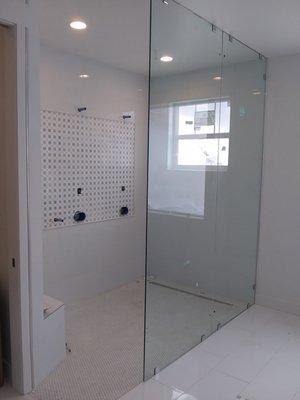 9 foot tall heavy glass shower wall. Clear with chrome clips. Hilton Glass and Door 208-263-3322