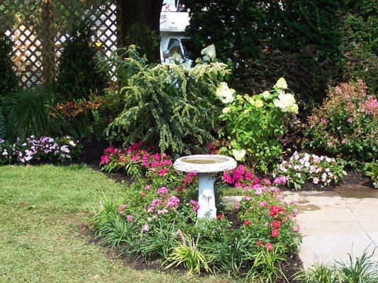 A well placed bird bath or statue makes a difference!