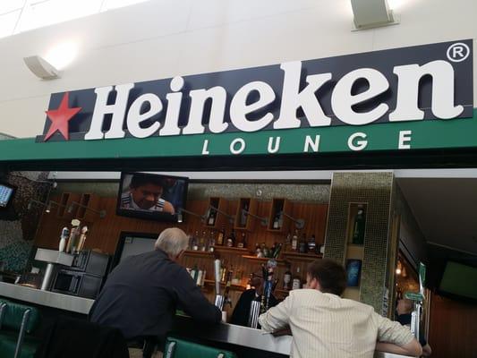 Heineken sign over top the beer bar.