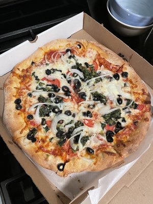 "Meat Lovers Pizza" with tomatoes, spinach, onions, and olives. Only theres no meat..