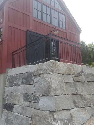 Hand split granite retaining walls with custom wrought iron railings in Center Conway, NH