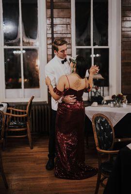 Bride in red dress dancing with Groom in white tux at the haunted Crescent Hotel