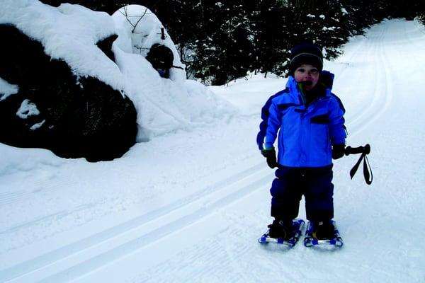 Look at how happy he is  snowshoeing for the first time.