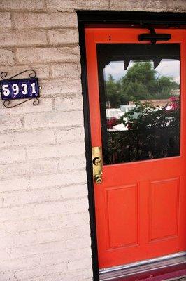 Enter through the orange door on the second floor.