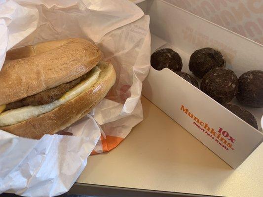 Sausage egg and cheese sandwich on a plain bagel wit double glazed munchkins