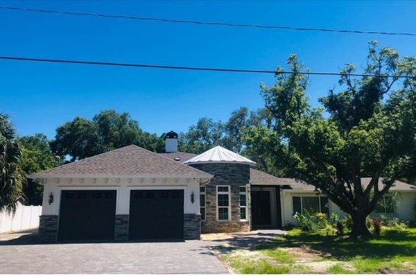 Custom home renovation included addition of over 2400 square feet. Exterior design featuring turret with stone accent, and 2 car garage.