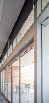 Discrete recessed shades for commercial space.