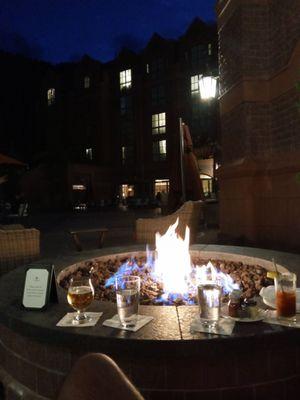 In the bar/hotel courtyard, have a few bevvies by the fire pit, looking at the Aspen mountains in the back of the hotel.