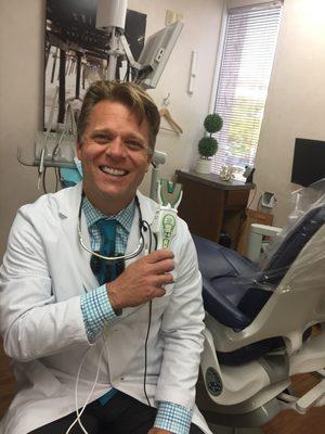 Dr. Eric Johnson using the newest bite technology. T-Scan, is a digital bite sensor that records a patients bite force.