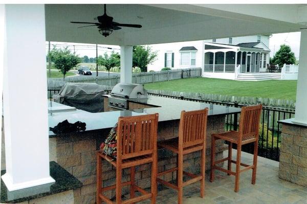 Outdoor kitchen next to pool