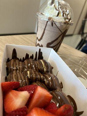 Mini pancakes drizzled with Nutella and dark Belgium chocolate topped with fresh strawberries and a Ferrero Rocher milkshake