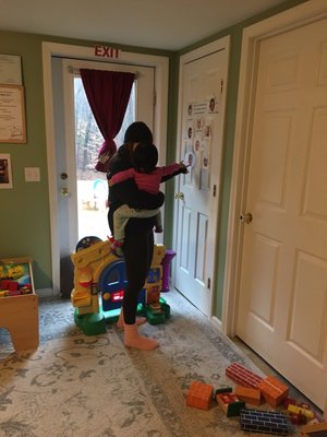 A mother and daughter looking at pictures on the wall.