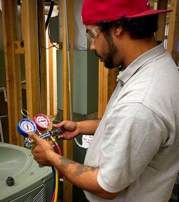 HVAC/R student working on an Air Conditioning Unit