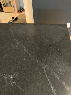 permanent stain from whatever sealant they used to "clean up" the spilled silicone.