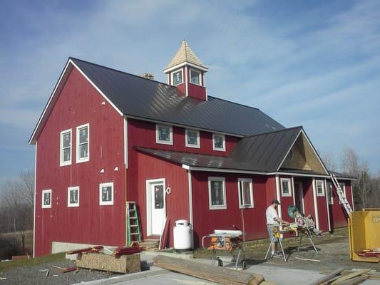 Standing Seam Metal Roofing; custom formed and installed on site.