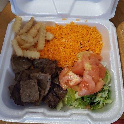 Halal Lamb over rice. Salad and french fries