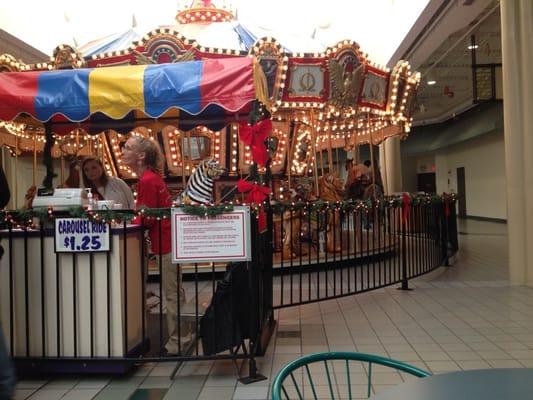 Carousel ride in middle of food area.