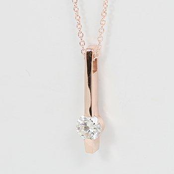 14 karat rose gold bar pendant set with a brilliant cut round Diamond.