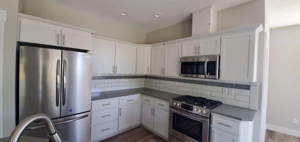 Kitchen cabinets, crown-molding and tile backsplash installation