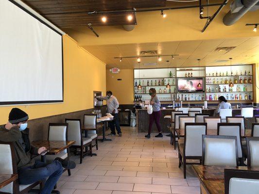 Wide space leading up to the bar and the counter where take out orders can be picked up.