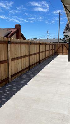 Standard Cedar fence with PostMaster Steel Posts set in new concrete slab.