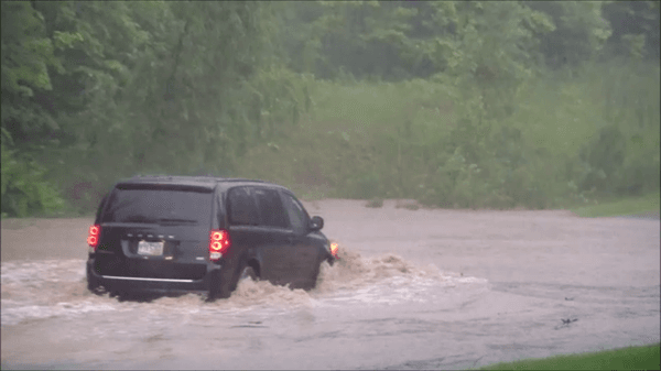 Van stuck in water from Zilich property