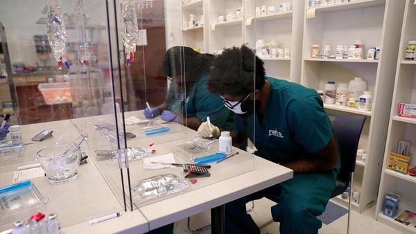 Pharmacy Technician program students practicing preparing medication bottles