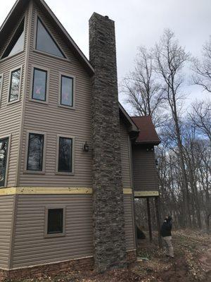 New vinyl siding with seamless gutters, soffit, fascia and faux stone in Dover, Pa