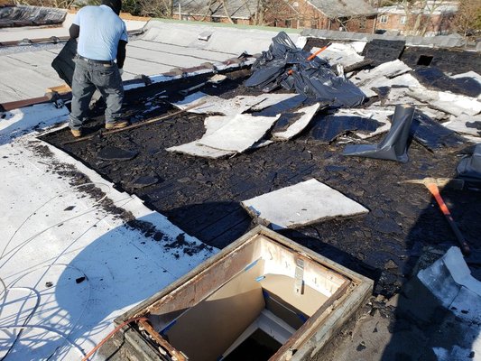 Removing the old roof to prepare for the new roof membrane with insulation.