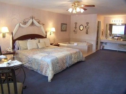 A honeymoon suite with a king bed, fireplace and jacuzzi for you two to share.