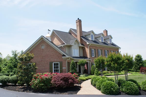 The landscaped entrance walk past the rear loaded garage and covered side porch entry to the main entrance.