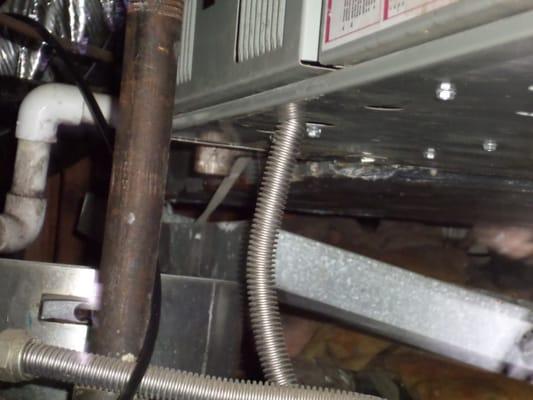 Gas Flex line entering the furnace is a fire hazard. Identified during the Home inspection.