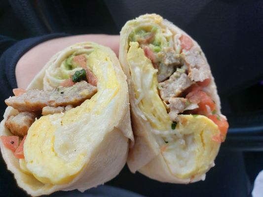 Delicious breakfast burrito - egg, sausage, shredded cheese, avocado, pico de gallo, and cheese sauce. I will definitely get again!