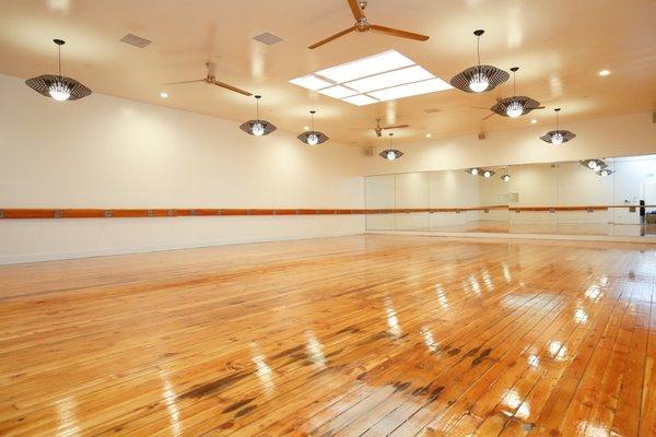 Original hickory hardwoods, chic pendants and a gorgeous skylight make the studio space shine.