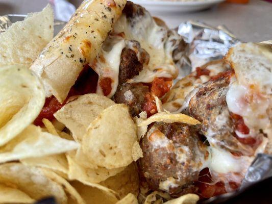 Meatball Sub.  Lays Potato Chips and cold tomato sauce.