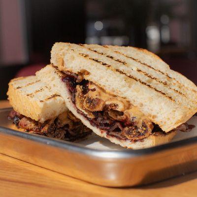 "PB&Grey". Grilled, candied Figs and bacon with Gus&Grey Blueberry Lavender Jam, Peanut Butter on Chargrilled Tuscan Sourdough.