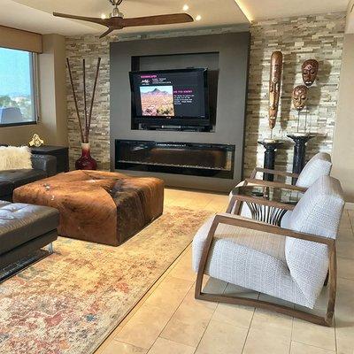 Contemporary World Traveler Living Space Featuring Custom Oversized Cowhide Ottoman and Floating African Masks.