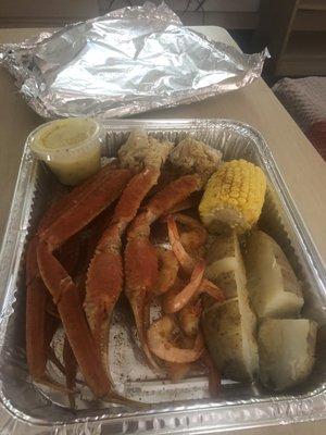 Snow crab, and shrimp platter with corn and potatoes.