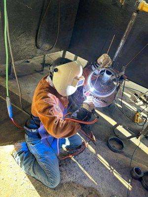 This welder is welding on a test coupon with the TIG process.