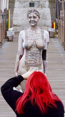 Trina Merry photographing influencer Taylor La Vie on the Brooklyn Bridge