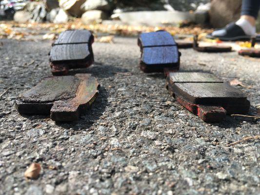 My rear brake pads - low angle view. Can clearly see the left brake pad is much more worn than the right.