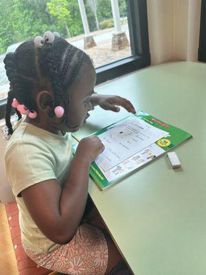 Courtlyn completing Kumon reading practice at the library.