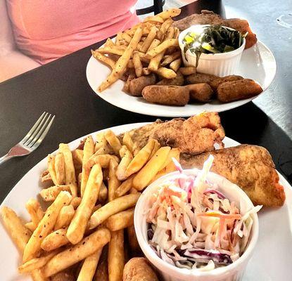 Fried flounder dinners with fries, hush puppies, and coleslaw (front) / collard greens (rear)