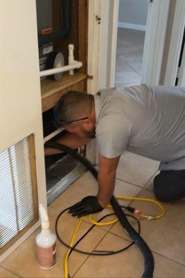 Vacuuming return duct, getting ready to sanitize duct system