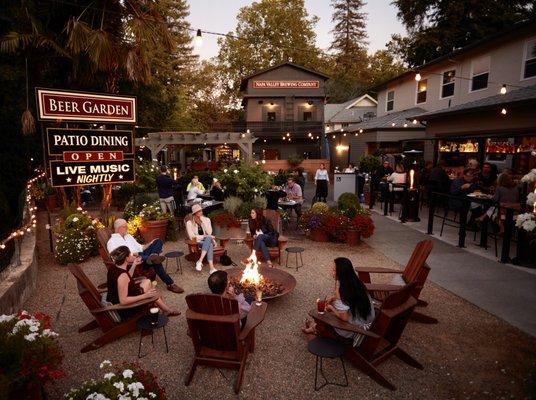 Guests enjoying the fire pit at the entrance to our 150 seat patio on the Napa River